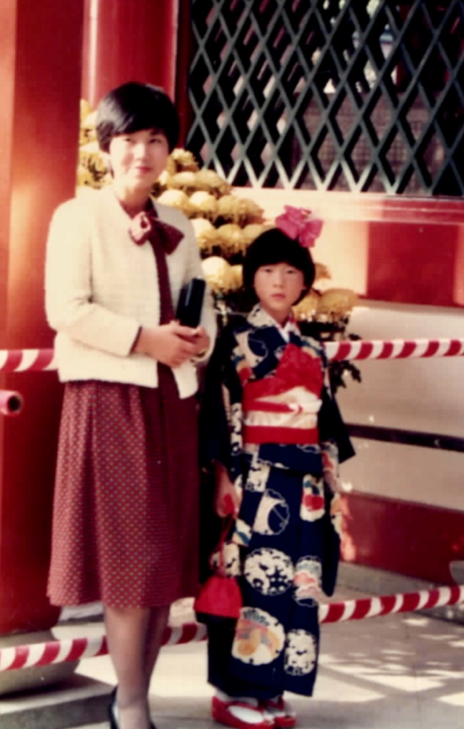 With my mother. The heavy kimono made of crepe fabric was quite heavy for a 7-year-old child